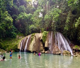 Relaxation and adventure at beautiful Reach Falls, a tropical eco waterfall attraction in Jamaica (Caribbean) in the Portland Parish close to Long Bay with cascades, pools and lush greenery